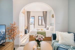 a bedroom with a bed and a couch and a table at Label6 To Ngoc Van - Crescendo Boutique Studio in Hanoi