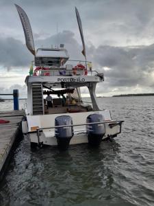 a boat parked at a dock in the water at Yate PORTOBELO LUXURY in Buenaventura +6 photos