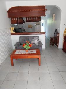 a living room with a couch and a coffee table at Chez Rosalie in Lamentin +6 photos