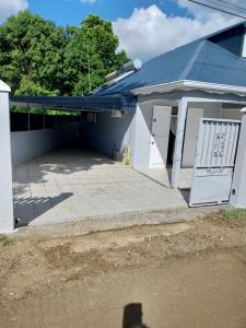 a white house with a large patio at Chez Rosalie in Lamentin