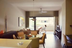 a living room with a couch and a table at Residence Alizees Spa in Mauritius