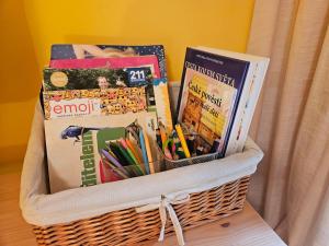 a basket filled with books and magazines on a table at Rodinný apartmán Pec pod Sněžkou 3 - 1x parking available in Pec pod Snezkou