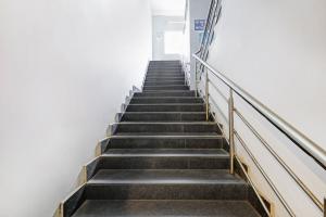 a stairway in a building with a stair case at Hotel O New Jebii's Inn in Kāhārpāra