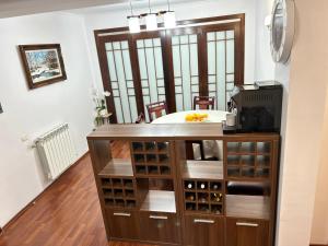 a kitchen with a counter with wine bottles at Casa Joy in Bucharest