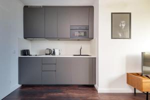 a kitchen with a sink and a microwave at Studio des roses place des Martyrs hyper centre in Ferme Thibesart