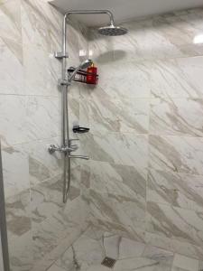 a shower with a glass door in a bathroom at Hostel House ЖК Ожет in Almaty