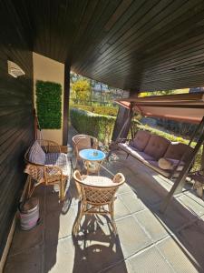 a patio with a couch and chairs and a table at Apartment ZAX B7 in Terra Complex in Bansko