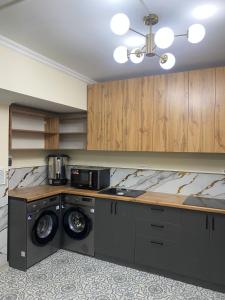 a laundry room with a washer and dryer at Hostel House ЖК Ожет in Almaty