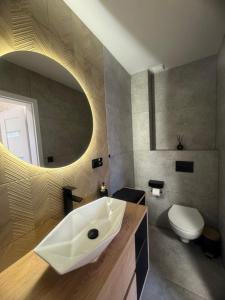 a bathroom with a white sink and a toilet at Przystanek Niesiołowice - na Kaszubach in Niesiołowice +13 photos