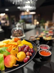 a plate of fruit on a table at Saltstraumen Hotel og Fjordhytter in Bodø