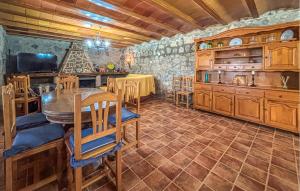 a kitchen with a table and some wooden cabinets at Stunning Home In Mula in El Niño