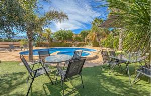 a patio with a table and chairs and a pool at Stunning Home In Mula in El Niño