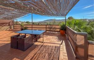 a patio with a blue table on a deck at Stunning Home In Mula in El Niño +35 photos