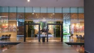 a lobby of a building with glass doors and chairs at M City in Kuala Lumpur +290 photos