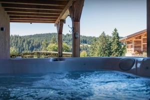 a jacuzzi tub with a view of the mountains at Chalet K - OVO Network in Chelou