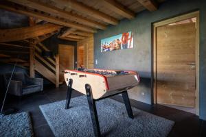 a room with a foosball table in a room at Chalet K - OVO Network in Chelou +17 photos
