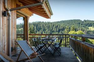 a deck with a table and chairs on a cabin at Chalet K - OVO Network in Chelou
