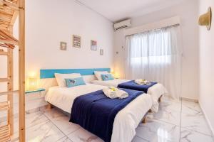 twee bedden in een kamer met blauw en wit bij Kaz du Poete in Saint-Pierre