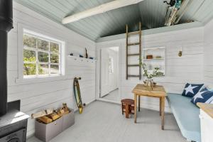 a living room with a table and a couch at 200-Year-Old House By The Southern Archipelago in Mandal