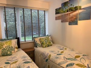 a bedroom with two beds and a window at Paradise in Marston Green