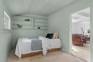 a bedroom with a bed in a room at 200-Year-Old House By The Southern Archipelago in Mandal