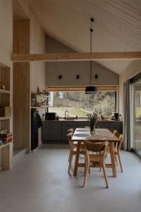 a kitchen and dining room with a table and chairs at Wood Rest, MyWeek in Stronie Śląskie