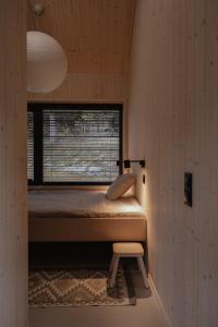 a small room with a bed and a window at Wood Rest, MyWeek in Stronie Śląskie