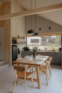 a kitchen and dining room with a table and chairs at Wood Rest, MyWeek in Stronie Śląskie