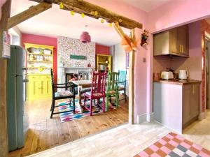 a kitchen with a table and chairs in a room at Drew Street Digs in Brixham