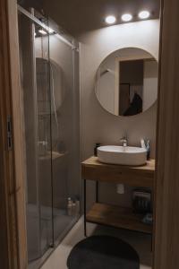 a bathroom with a sink and a shower with a mirror at Wood Rest, MyWeek in Stronie Śląskie +25 photos