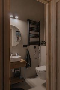 a bathroom with a sink and a toilet and a mirror at Wood Rest, MyWeek in Stronie Śląskie