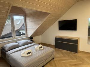 a bedroom with a bed with two towels on it at Przystanek Niesiołowice - na Kaszubach in Niesiołowice
