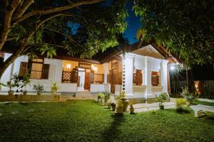ein Haus mit einem Rasen davor in der Nacht in der Unterkunft Chali' Villa in Matale + 13 Fotos