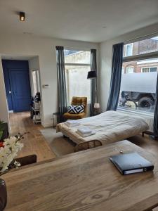 a bedroom with a bed and a table with a book on it at Cozy apartment in Utrecht in Utrecht