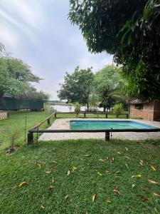 an empty swimming pool in a field with a tree at Proudly Okavango self-catering Burnside in Shakawe