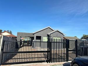 a black fence in front of a house at 29 Windsor Flatlet 2 in Silver Sands