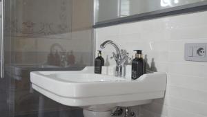a white sink with two bottles on it in a bathroom at PALAZZO RICARDI Chambres d'hotes in Imperia +31 photos