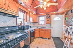 a kitchen with a stove and a ceiling fan at Choice home in West Babylon
