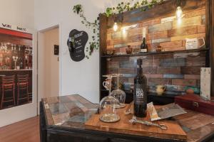 a table with a bottle of wine and two glasses at San Francesco Lodge&Art Hostel in Trieste +33 photos