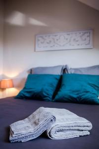 a white towel is laying on a bed at Kaz Combava in Étang-Salé