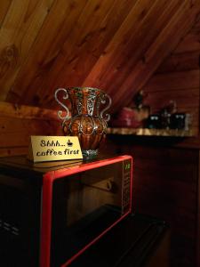 a trophy is sitting on top of a microwave at The Dapper Duck Log Cabin in Cosby +10 photos
