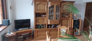a large wooden entertainment center in a living room at Schweizerhaus Aue in Aue-Bad Schlema