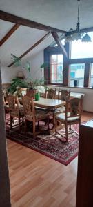 a dining room with a table and chairs at Schweizerhaus Aue in Aue-Bad Schlema +6 photos