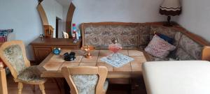 a dining room table and chairs with a wooden table at Schweizerhaus Aue in Aue-Bad Schlema