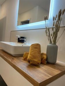 a bathroom counter with two towels and a sink at Casa Antonius in Lebach +6 photos