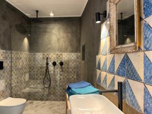 a bathroom with a sink and a toilet and a shower at IL CORVO DI PIETRA in Scicli +100 photos