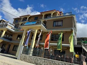 a building with flags in front of it at Hotel Grand Shambala in Muktināth