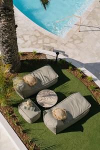 un cercle de coussins sur l'herbe à côté d'une piscine dans l'établissement President Hotel, au Cap