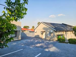 a house with a driveway in front of it at The M GuestHouse in Kempton Park