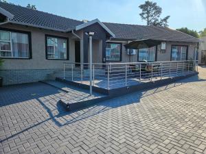 a house with a patio with an umbrella at The M GuestHouse in Kempton Park +160 photos